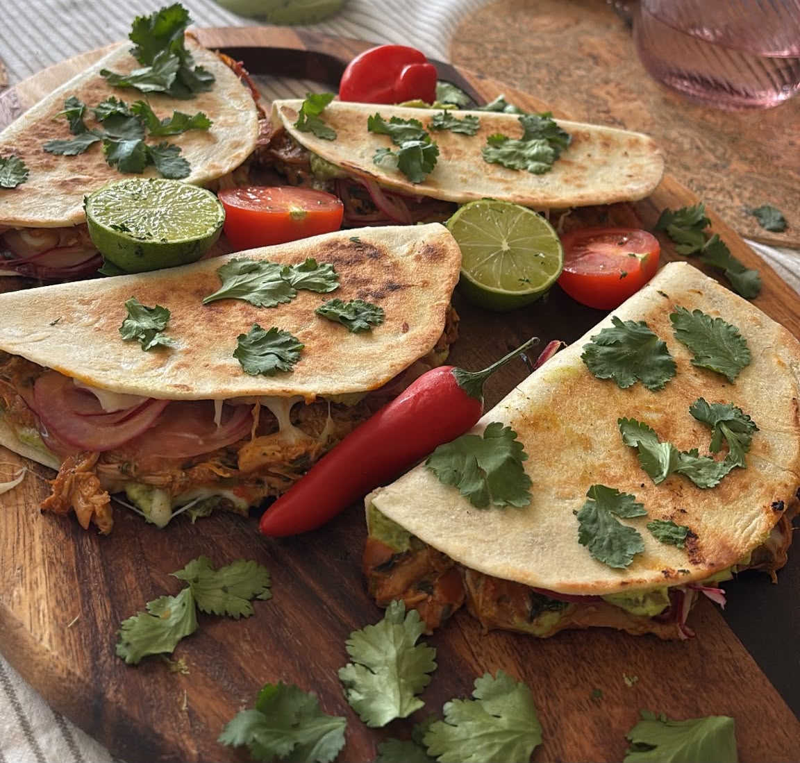 Crispy folded parcels topped with fresh coriander, lime and chilli on a wooden board